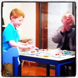 5-year old Jeremy playing Monopoly with his grandpa.