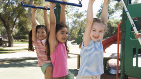 Girls playing on monkey bars